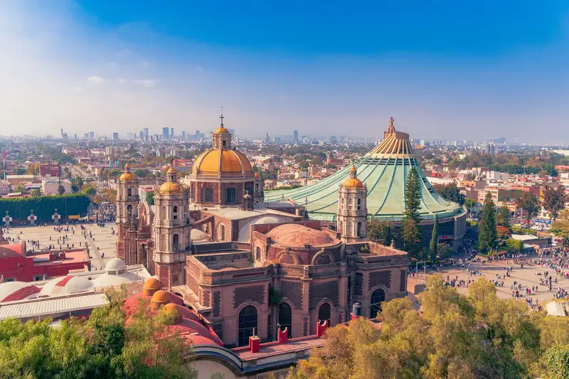 Stunning view of the Basilica of Our Lady of Guadalupe with a Mexico City skyline backdrop, showcasing religious devotion.
